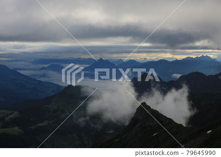 Sunrise scene seen from Mount Brienzer Rothorn. View towards Stanserhorn and Lucerne. Fog lifting slowly after a rainy night. 79645990
