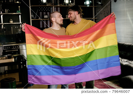 Homosexual Men Holding Rainbow Flag Homosexual Men Holding Rainbow Flag 79646007