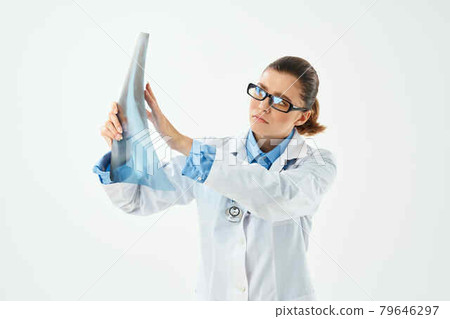 woman doctor in white coat looking at x-ray diagnostics close-up woman doctor in white coat looking at x-ray diagnostics close-up 79646297