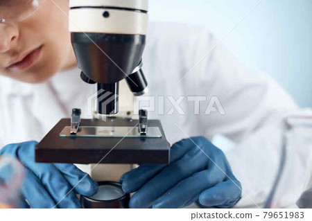 woman scientist microscope research technology analysis work 79651983