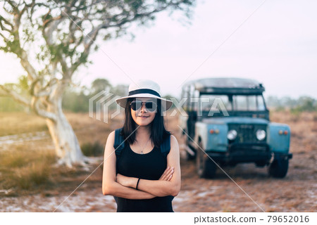 Hipster traveller asian woman standing and cross arms at nature on during sunset,Relax time Hipster traveller asian woman standing and cross arms at nature on during sunset,Relax time 79652016