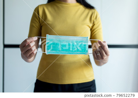 Woman hands holding face mask protective for spreading of disease virus,COVID-19 pandemic coronavirus Woman hands holding face mask protective for spreading of disease virus,COVID-19 pandemic coronavirus 79652279