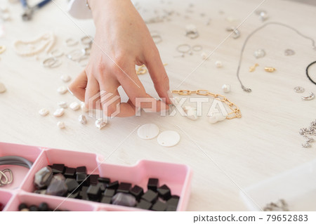 Professional jewelry designer making handmade jewelry in studio workshop close-up. Fashion, creativity and handmade concept 79652883