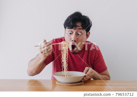 Wow and surprised funny face of man eat instant noodle. 79653712