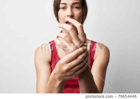 woman holding hand finger pain treatment medicine woman holding hand finger pain treatment medicine 79654446