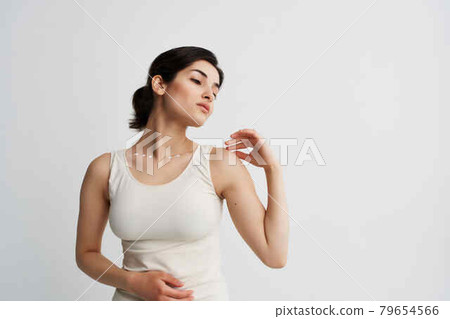 brunette with lotion in hands cosmetics skin care light background brunette with lotion in hands cosmetics skin care light background 79654566