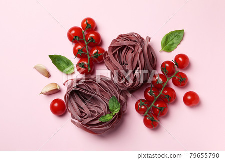 Uncooked pink pasta and ingredients on pink background 79655790
