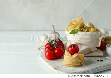 Concept of cooking tasty pasta on white wooden table Concept of cooking tasty pasta on white wooden table 79655797