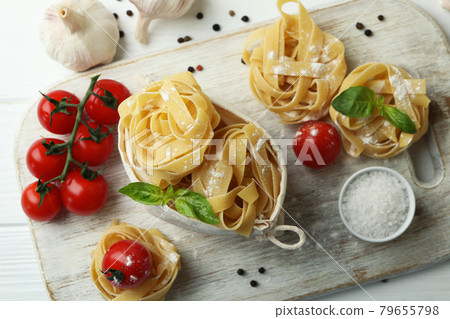 Concept of cooking tasty pasta on white wooden table Concept of cooking tasty pasta on white wooden table 79655798