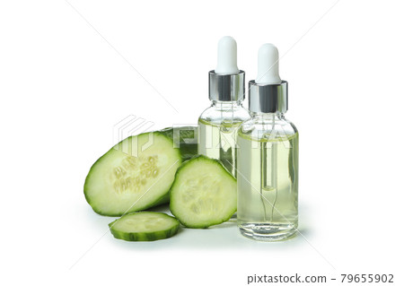Bottles with oil and cucumber isolated on white background 79655902