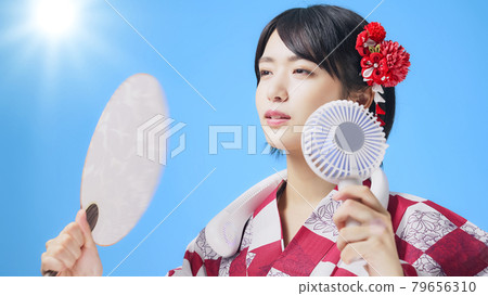A woman in a yukata who uses a handy fan, a neck fan, and a fan 79656310