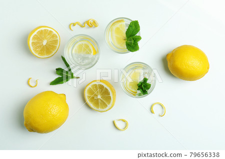 Shots of vodka and lemons on white background Shots of vodka and lemons on white background 79656338
