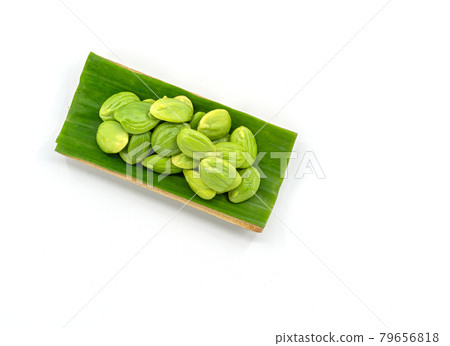 Top view fresh bitter beans in the natural tray by banana leaf for sale on white background, bitter beans or Sator in Thailand language. 79656818
