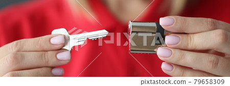 Female hands hold key and lock closeup Female hands hold key and lock closeup 79658309