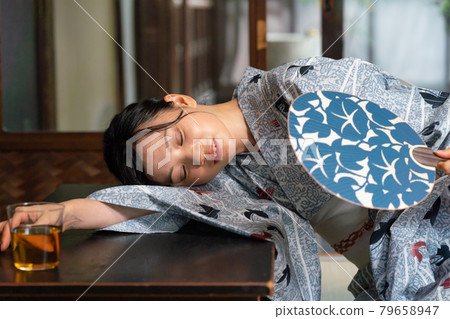 A woman who is exhausted by the heat of summer 79658947