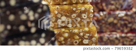 Multi-colored brittle are on counter of store Multi-colored brittle are on counter of store 79659382