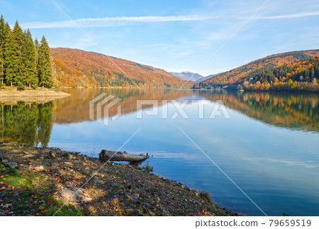 Vilshany water reservoir on the Tereblya river, Transcarpathia, Ukraine. Picturesque lake with clouds reflection. Beautiful autumn day in Carpathian Mountains. Vilshany water reservoir on the Tereblya river, Transcarpathia, Ukraine. Picturesque lake with clouds reflection. Beautiful autumn day in Carpathian Mountains. 79659519