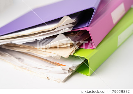 File Folder Binder stack of multi color on table in office. File Folder Binder stack of multi color on table in office. 79659882
