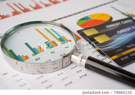 Credit card  with Magnifying glass on chart and graph paper. Finance development, Banking Account, Statistics, Investment Analytic research data economy, Stock exchange trading, Business company 79660126