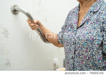 Asian senior or elderly old lady woman patient use toilet bathroom handle security in nursing hospital ward, healthy strong medical concept. 79660148