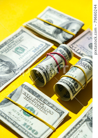 US dollars bundle close up isolated on dollar background. Paper denominations of dollars cash rolls with rubber bands. Business budget of wealth and prosperity finance. 79660244