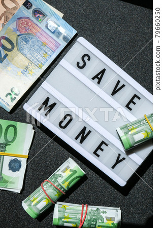 Lightbox board with word SAVE MONEY in black letters around euro banknotes. Money, Business, finance, investment, saving Lightbox board with word SAVE MONEY in black letters around euro banknotes. Money, Business, finance, investment, saving 79660250
