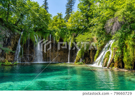 Waterfall with turquoise water in the Plitvice Lakes National Park, Croatia. 79660729