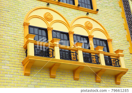 The windows of the building are colorful. The windows of the building are colorful. 79661285