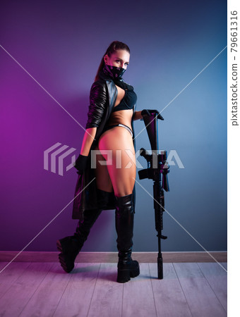 sexy female killer in underwear and a leather raincoat and long leather shoes with an m16 automatic rifle with a telescopic sight 79661316