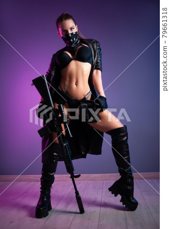 sexy female killer in underwear and a leather raincoat and long leather shoes with an m16 automatic rifle with a telescopic sight 79661318