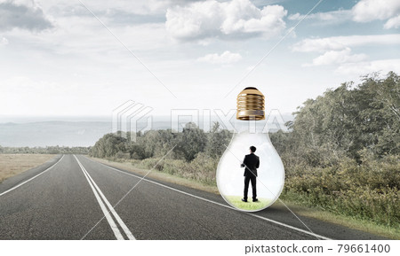 Businessman inside light bulb Businessman inside light bulb 79661400