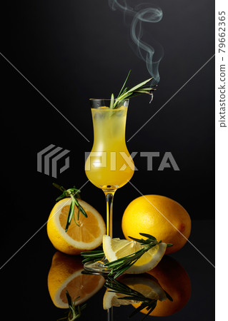 Traditional homemade lemon liqueur limoncello on the black background. 79662365