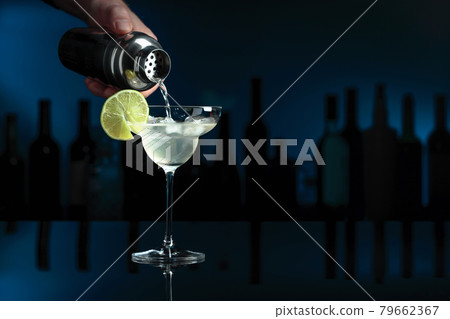 Cocktail "Margarita" on a black table in a bar. 79662367