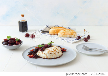 Grilled Camemberts cheese, cherries with honey and balsamic vinegar syrup 79662482