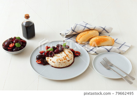 Grilled Camemberts cheese, cherries with honey and balsamic vinegar syrup 79662495