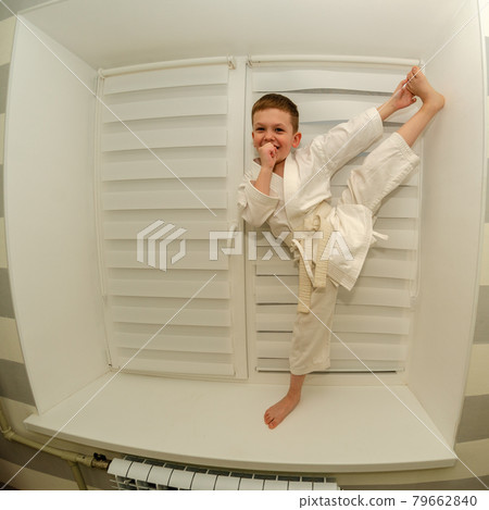 Little boy of preschool age does morning exercises on a home horizontal bar 79662840