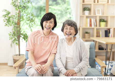 Smiley caregiver and senior woman Smiley caregiver and senior woman 79663171