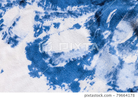 Tie-dye cotton fabric texture blue and white paint colors. Ancient resist-dyeing textile coloring technique,trendy cloth Tie-dye cotton fabric texture blue and white paint colors. Ancient resist-dyeing textile coloring technique,trendy cloth 79664178