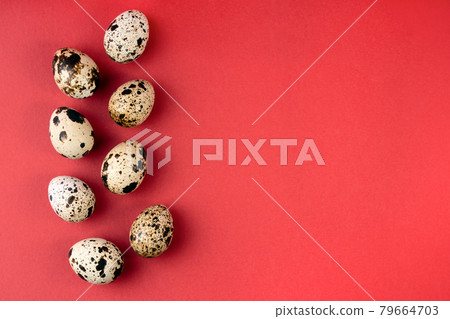 Creative quail egg layout on red background. Happy easter concept. Minimal design. Creative quail egg layout on red background. Happy easter concept. Minimal design. 79664703