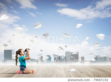 Concept of careless happy childhood with girl looking in binoculars Concept of careless happy childhood with girl looking in binoculars 79665192