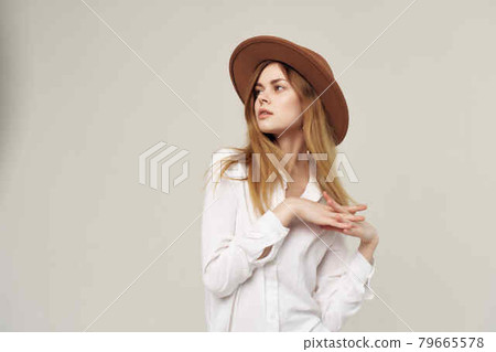 attractive woman in white shirt wearing hat decoration fashion modern style 79665578