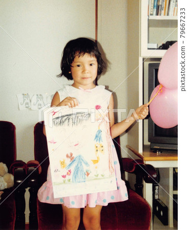 Old film photo Kindergarten girl showing a drawing 79667233