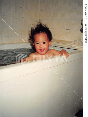 Old film photo, a little girl taking a bath Old film photo, a little girl taking a bath 79667895
