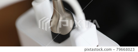 White usb cable is plugging into socket closeup White usb cable is plugging into socket closeup 79668023