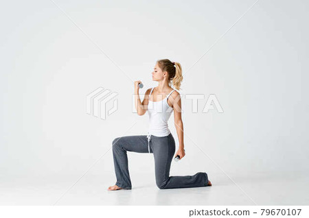 athletic woman with dumbbells exercise motivation workout slim figure 79670107