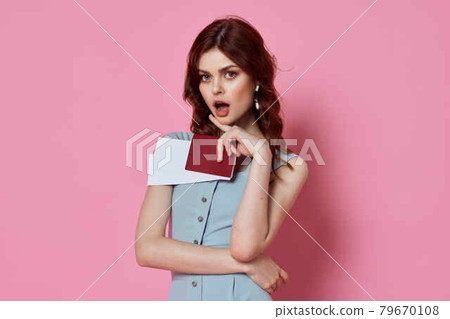 woman in blue dress with passport and plane tickets charm pink background passenger 79670108