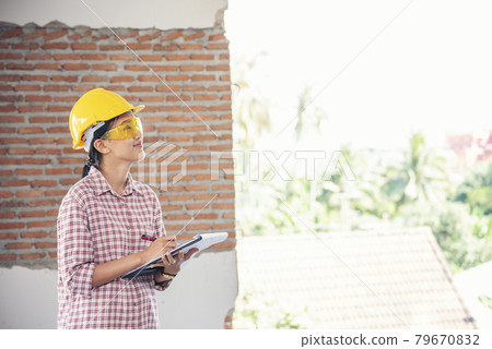 Woman construction engineer wear safety white hard hat at construction site industry worker. Female engineer worker civil engineering with hard hat safety helmet. Woman construction Engineer concept 79670832