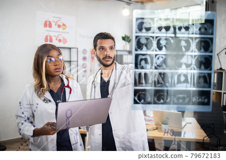 Multiethnic medical workers having daily briefing in modern offices with glass wall Multiethnic medical workers having daily briefing in modern offices with glass wall 79672183