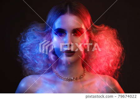 Portrait of a beautiful woman with bright evening makeup and colored filters. 79674022