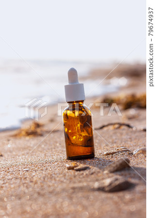 Cosmetic serum in glass dropper with pipette in water 79674937